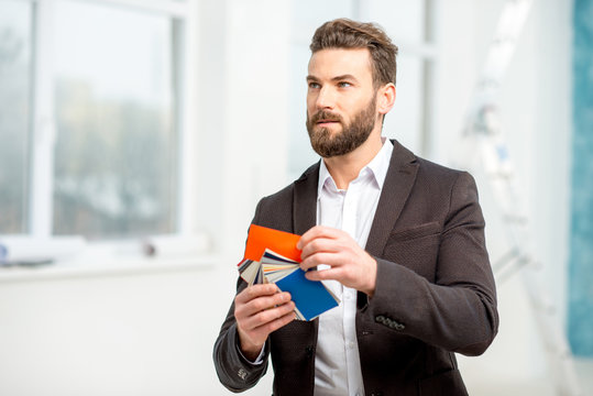 Elegant architect or designer choosing color for painting walls or apartment decotation from the color sample