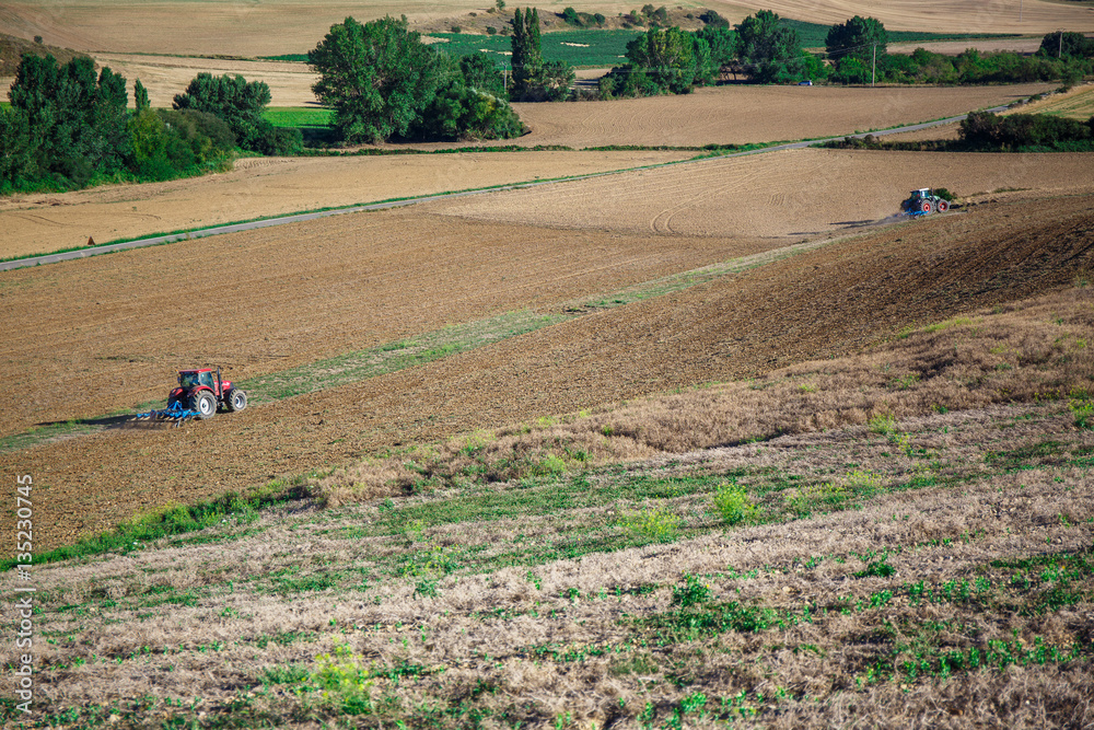 Wall mural tractor plowing field