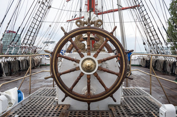 Wooden steering wheel of the sailboat. © gabort