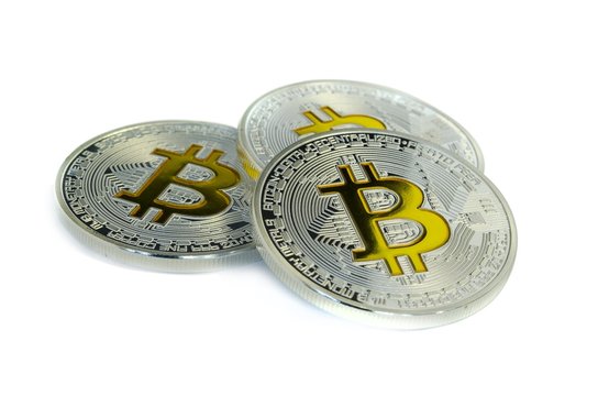 Focused Bitcoin coins laying on white background
