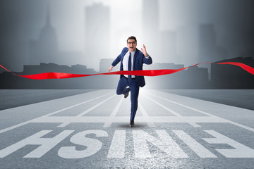 Businessman on the finishing line in competition concept