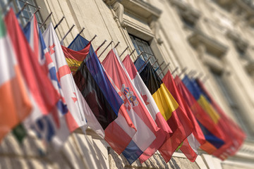 Colorful flags from different countries, blurred photo, moody toned effect, Hofburg, Vienna, Austria