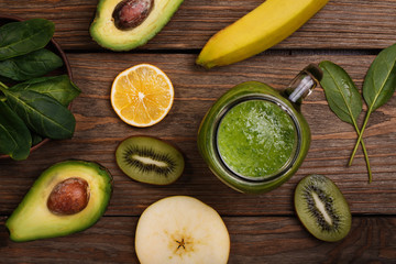 Fruit smoothies for cooking on a wooden table, top view