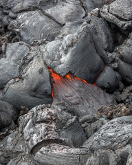 Molten lava flows on the surface of the cracks in the previously cooled lava - volcano Tolbachik,...
