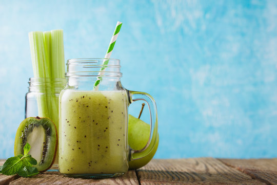 Smoothies of kiwi, celery and apple in a glass jar with space for text