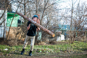 Young man and big log
