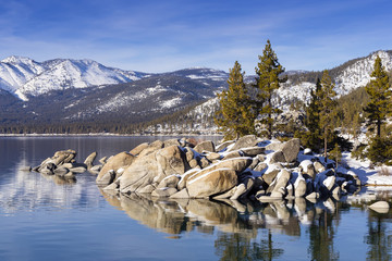 Winter shot of Lake Tahoe with snow on rocks and mountains.  Sand Harbor, Nevada