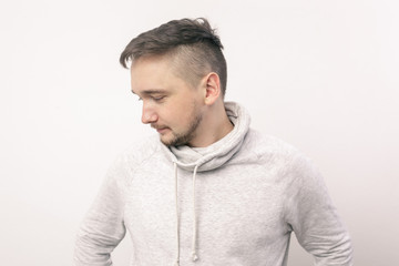 Fototapeta premium young man looks down guiltily. Depression and a sense of loneliness