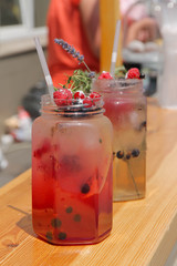 chilled drink with raspberries and currants in jar