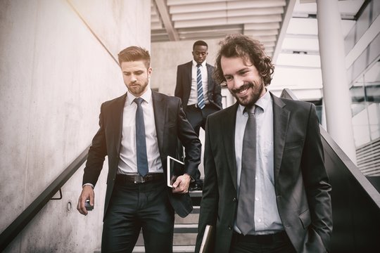 Group Of Businessmen Climbing Down Stairs