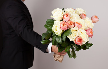 Man with big beautiful bouquet of nice flowers.