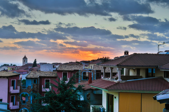 sunset between houses in Badesi 