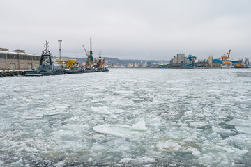 Tugboats and Ice in Port of Gdynia during winter season, Poland.