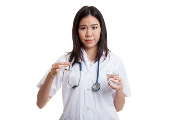 Young Asian female doctor with water and medicine.