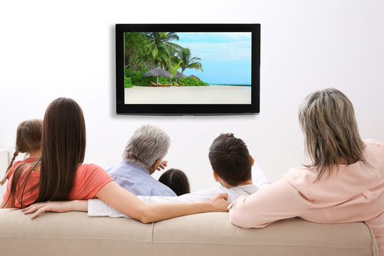 Family watching television at home. Leisure and entertainment concept.