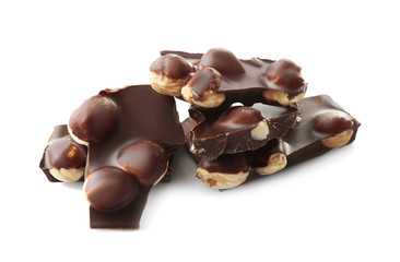 Broken chocolate pieces with hazelnut on white background