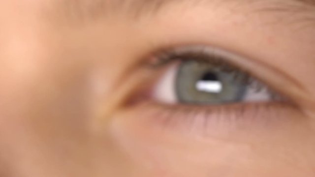 The boy opens and closes his eyes. Close-up 4K