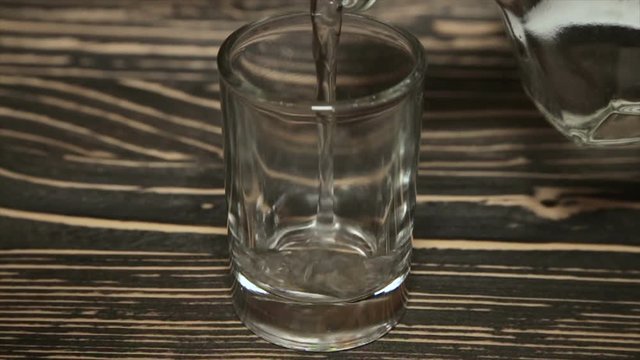 Poured a glass of vodka, close-up . Full hd video