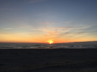 Pair sky Sun Rising over Waves 