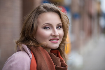Smiling beautiful young business woman in warm clothing enjoying time outdoors