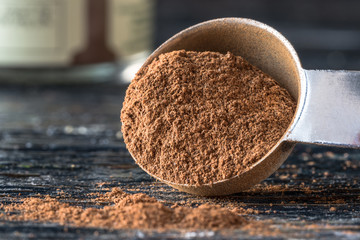 Ground Cinnamon Spilled from a Teaspoon