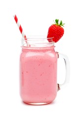 Pink strawberry smoothie in a mason jar glass with straw isolated on white