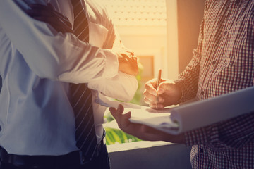 Obraz premium architect and engineer inspect housing estate building to success construction plan before send quality housing to customers ; smart team discuss and review construction plan 