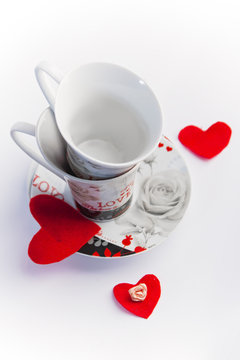 Valentine's Day: coffee cups with word Love inscribed, white bac