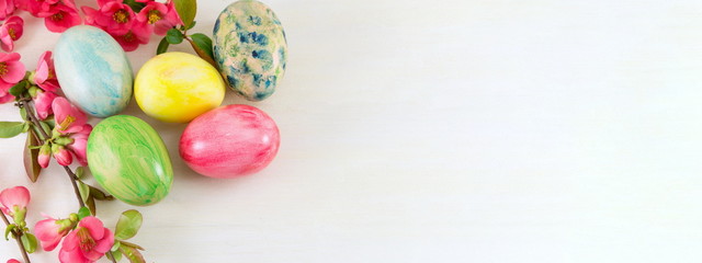 Fototapeta na wymiar Painted Easter eggs and Japanese rose flowers