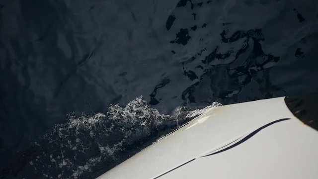 White bow on background of sea waves in Greece. Regatta. Adventures in the ocean. Slow motion.