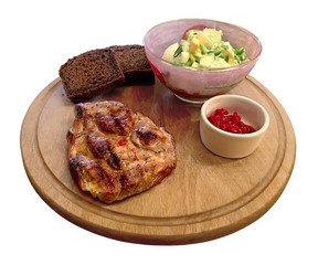 Piece of fried meat (steak) on a round board