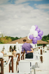 bride and groom walk on beach resort