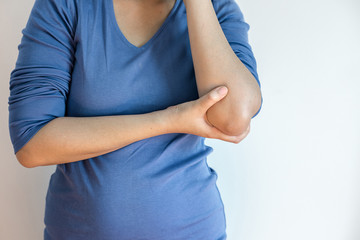 Woman touching her painful elbow