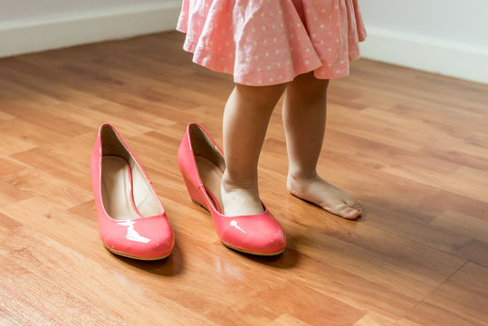 Baby Girl Wearing Her Mother's Shoes