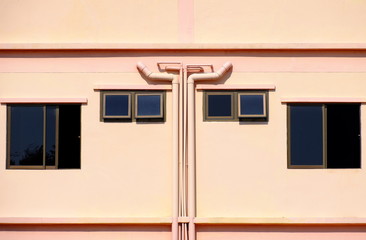 Water pipes and Windows on building with crepe color.