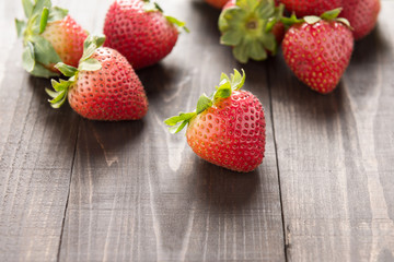Fresh red strawberries on old wooden background