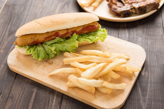Hot dogs, hamburgers and french fries on the wooden background