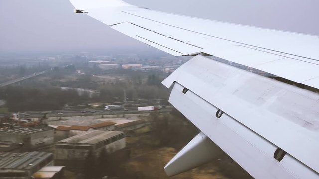 Wing of an Aircraft landing at Bergamo Orio al Serio Airport near Milan in Italy