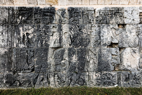 Ancient Mayan mural at the Great Ball Court in Chichen Itza depicting the ball players wearing protective clothing and decorated with feathers.