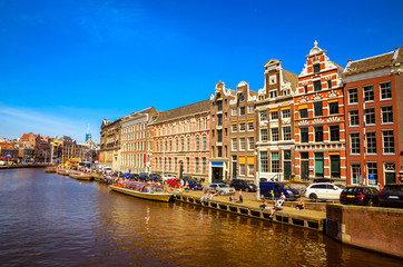 Fototapeta na wymiar Traditional old buildings and and boats in Amsterdam, Netherland