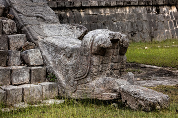 Fototapeta na wymiar Head of a serpent with its tongue out at the base of the staircase of the Ossuary pyramid at the Chichen Itza archaeological site in Yucatan, Mexico.
