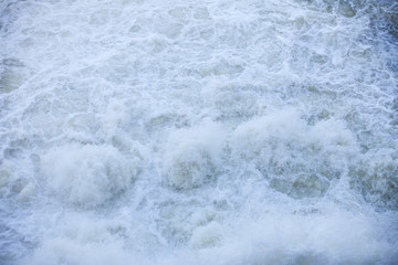 Water flowing from the open sluice gates of dam.