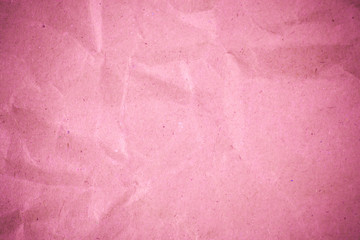 Pink crumpled recycle paper background.