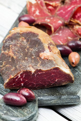 Smoked meat on the cutting board. Homemade smoked beef. Dried meat. Charcuterie.