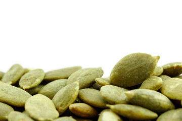 close up green pumpkin seeds on white background