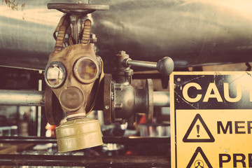 Fototapeta na wymiar Old Gas mask and warning sign.