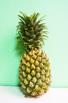 Isolated Yellow Pineapple on Mint Green Background