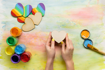 Obraz premium Person painting rainbow on heart shape for St Valentine's Day