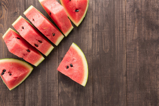 Slices of fresh watermelon on wooden background