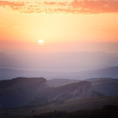 Sunrise over the mountains and the forest at dawn